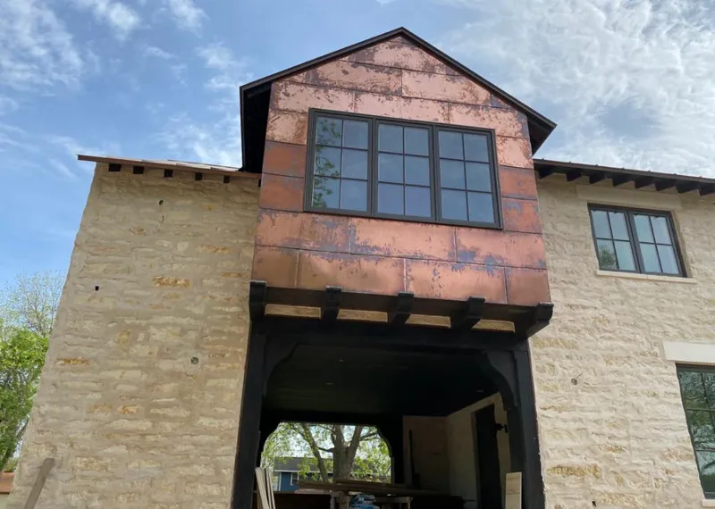 Copper metal panel facade on a stone building for Metal Roof Coating in Floral City